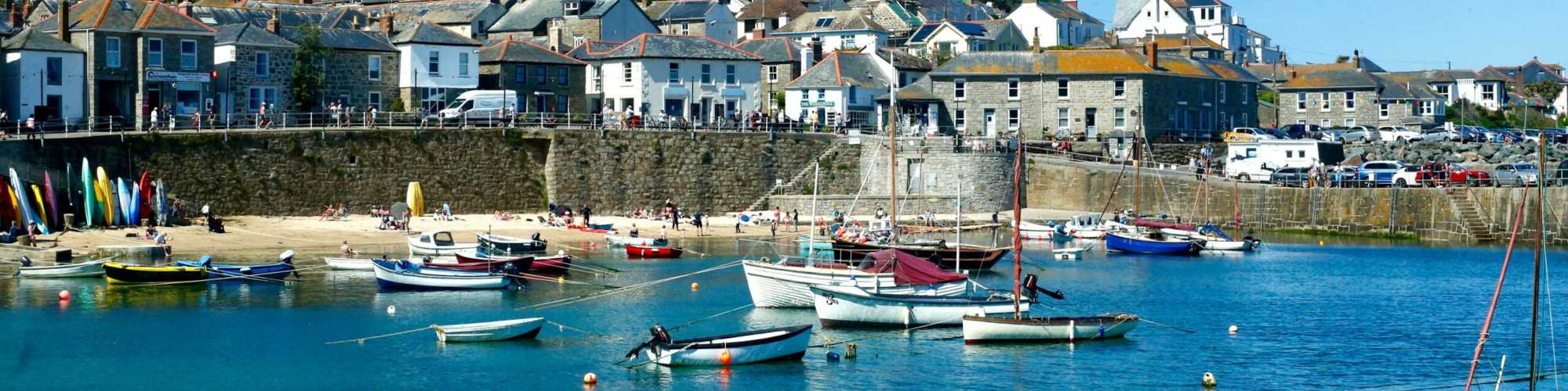View of Mousehole Harbour with boats